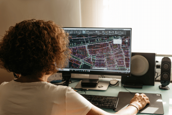 Developer building geospatial applications and working with GIS data on a computer workstation