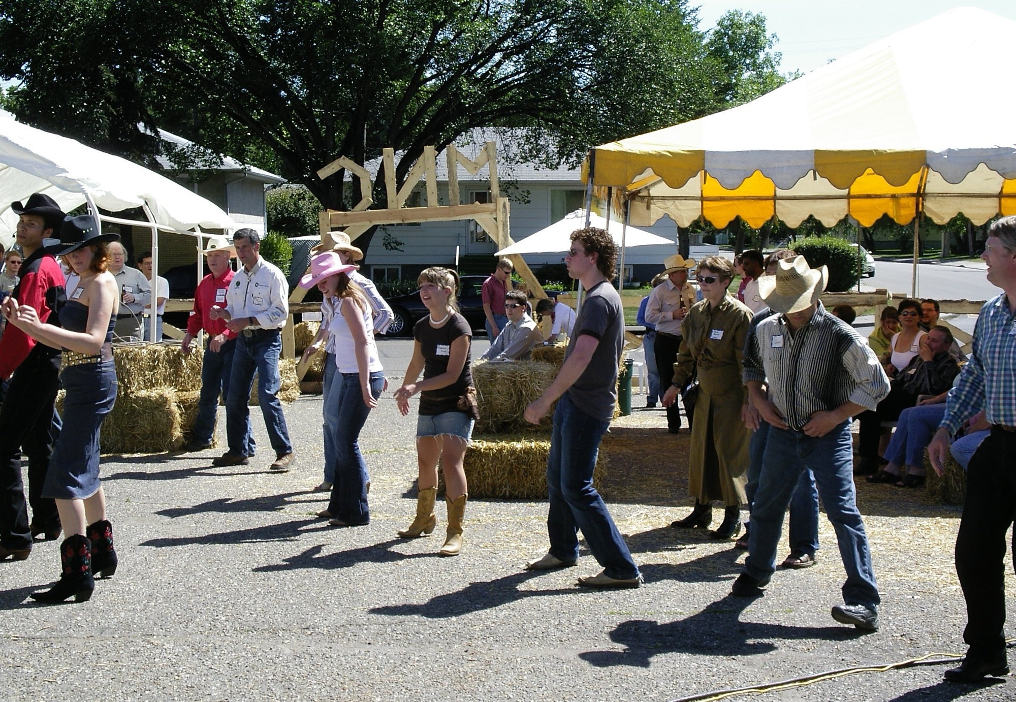 MNC team line dancing in the street at the Calgary Stampede