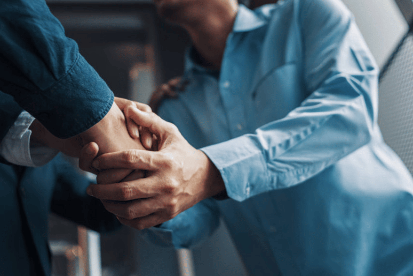 Professionals shaking hands representing trusted client partnerships and successful land administration projects