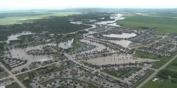 Aerial view of flooding in the community of High River, with water covering residential streets and neighborhoods.