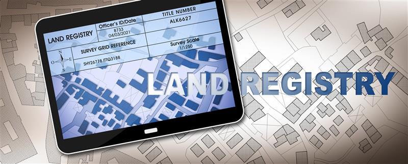 Digital land registry map displayed on tablet showing parcel boundaries and survey data